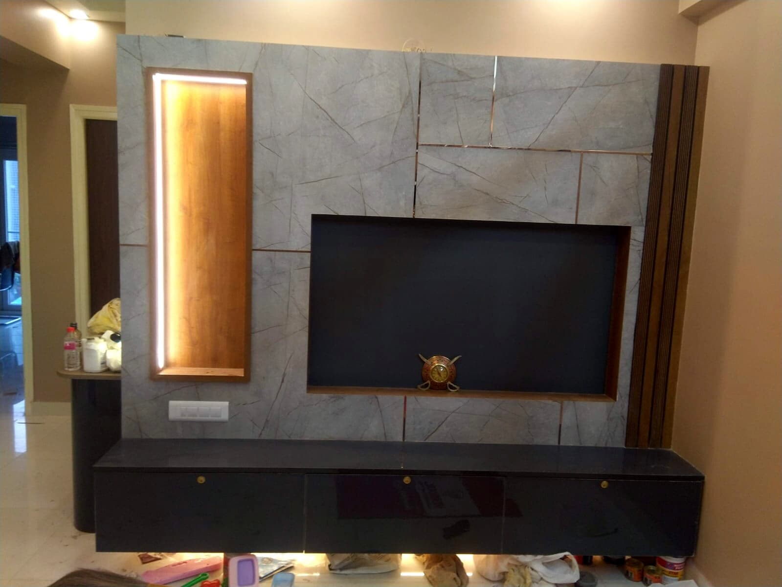 Sarjapur living room TV wall with marble finish and floating console